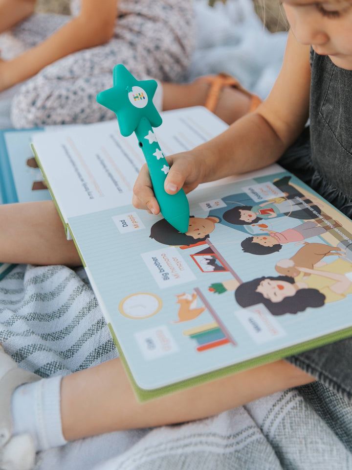 A child touching the Habbi Habbi Reading Wand to an image of a father.